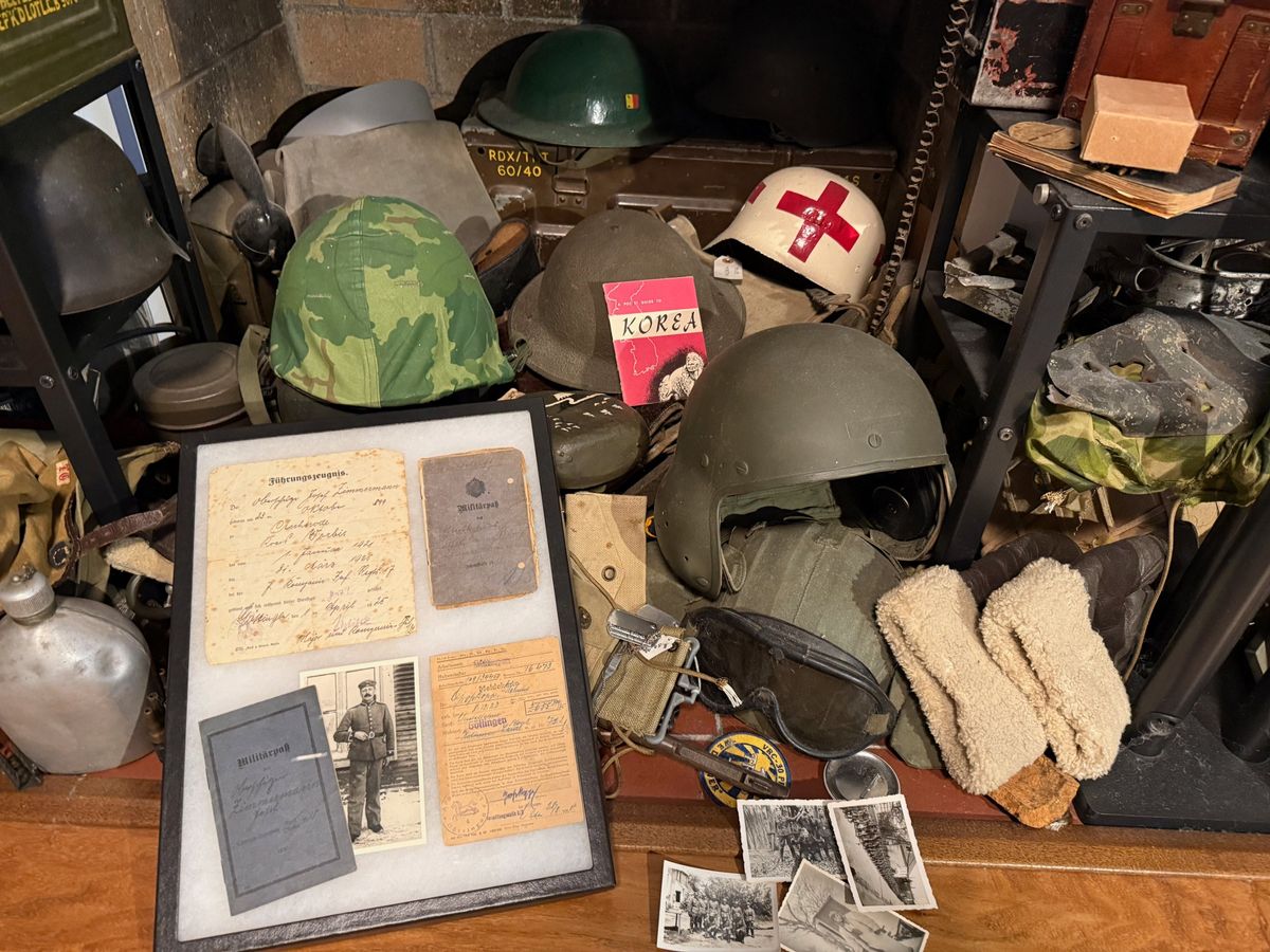 Part of Ethan's collection: military helmets, German military papers and photographs, and field gear