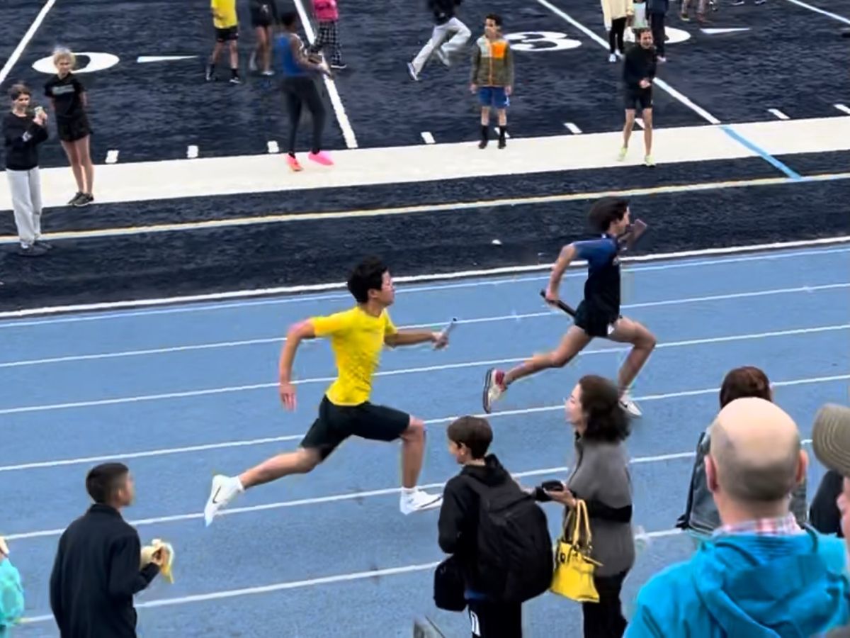 Ethan sprinting with the baton in a relay race