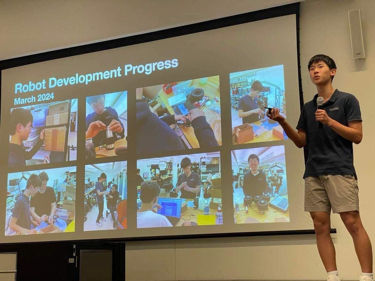 Ethan presenting a slide titled Robot Development Progress, March 2024, showing photos of the team building the robot