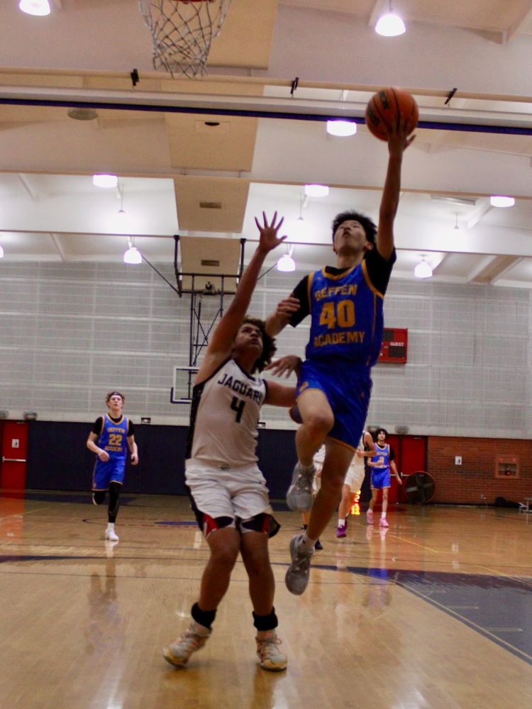 Ethan, number 40, going up for a layup in a varsity basketball game