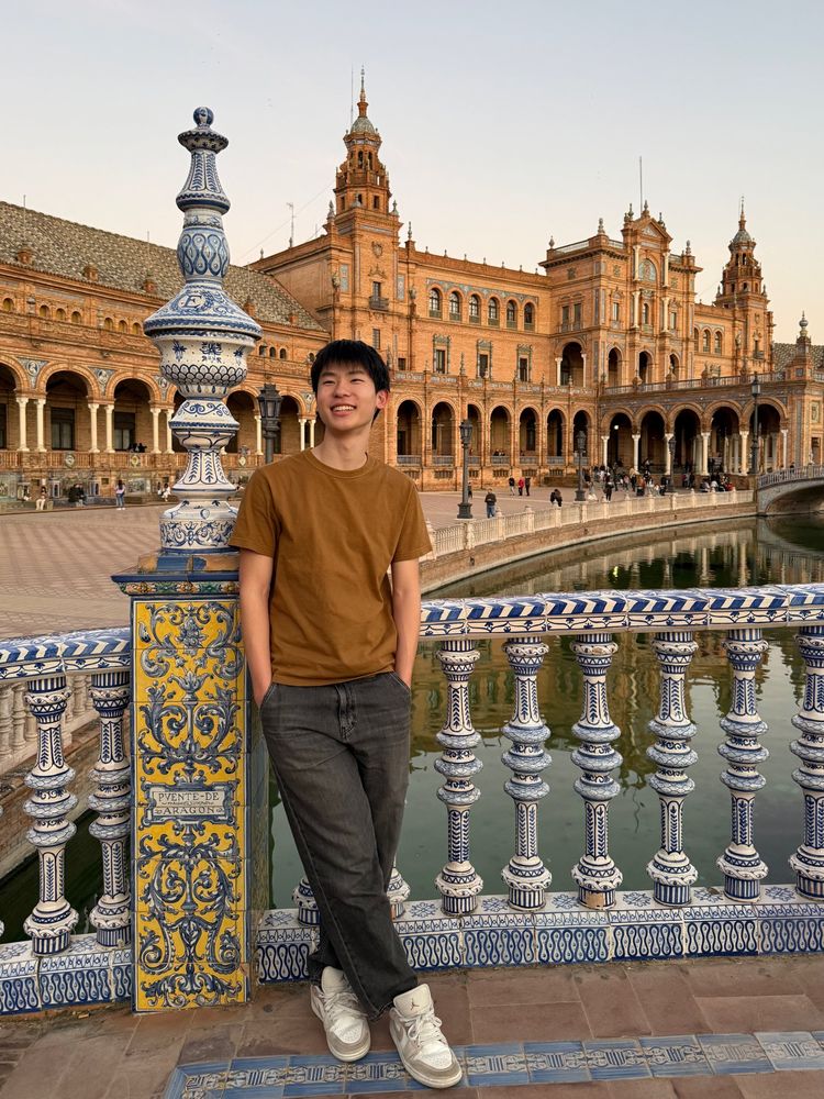 Ethan leaning on a tiled railing at the Plaza de España in Seville