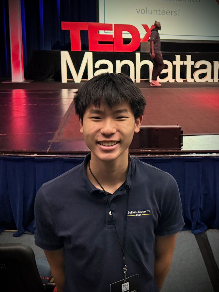 Ethan smiling in front of the TEDxManhattanBeach stage
