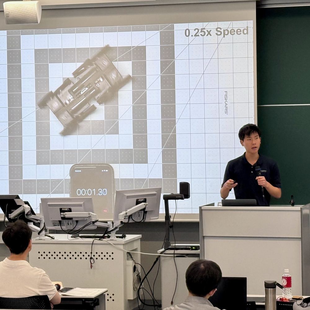Ethan presenting a slow-motion video of a Q8Bot running on a grid mat
